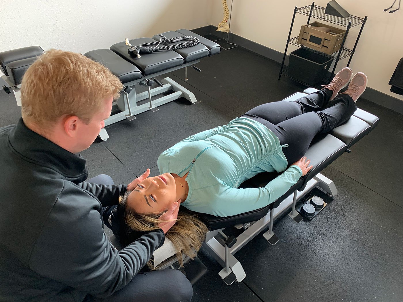 Chiropractor examining a patient with neck pain after a car accident